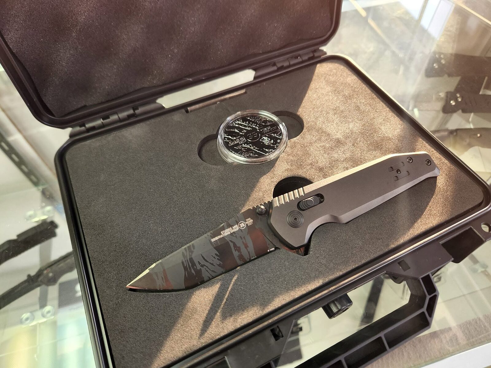 A limited-edition SOG knife and challenge coin in a hard case