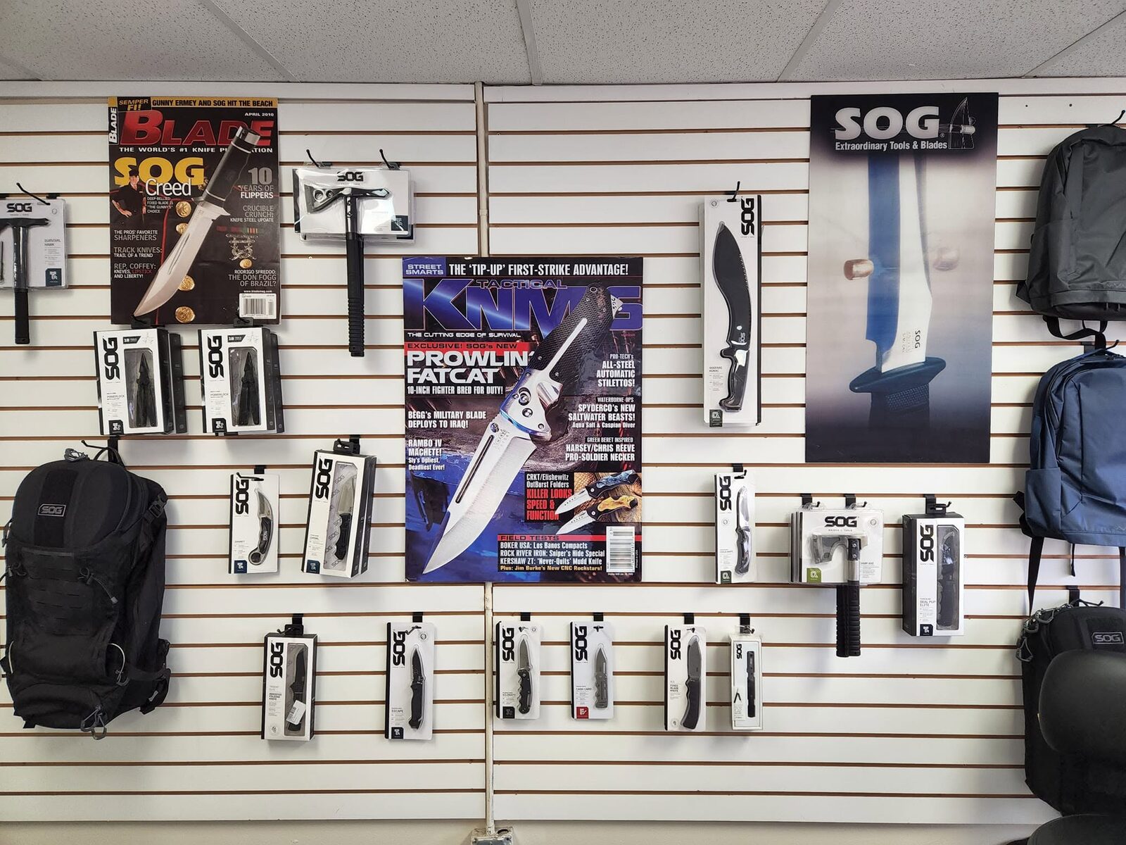 A wall of SOG products and vintage knife magazine covers